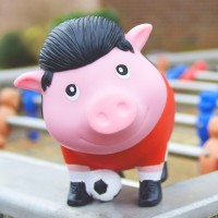 LILALU BIGGYS piggy bank soccer player on a foosball table