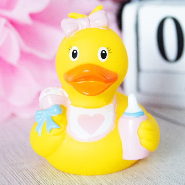 LILALU rubber duck baby girl in front of a pink flower