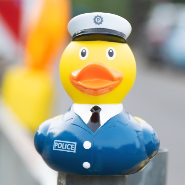 LILALU rubber duck Policeman sitting on a railing